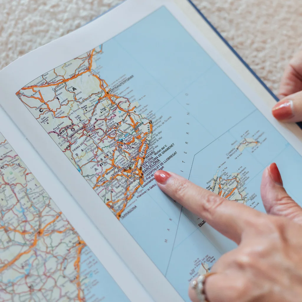 Property in Spain – hands pointing to different locations on a map of Spain.